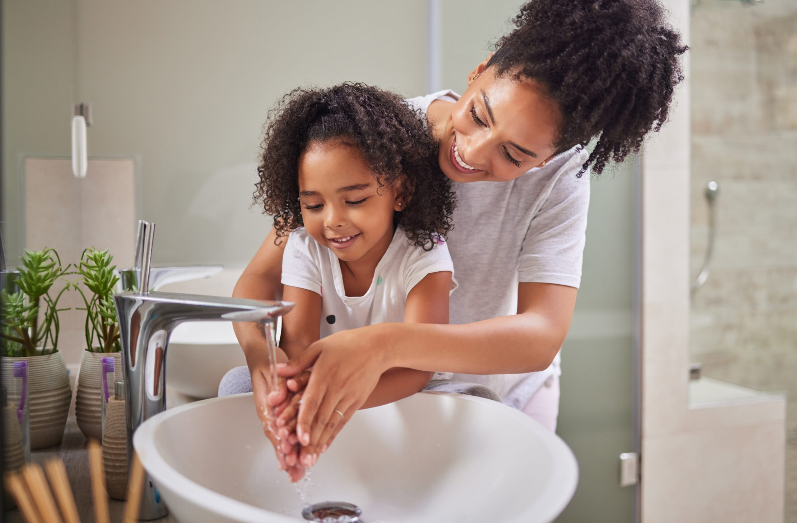 Mom and child washing their hands.